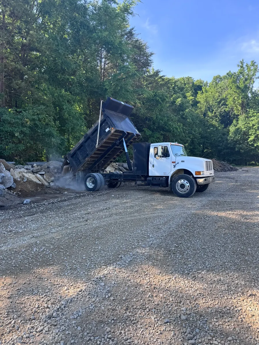 Dump truck delivering aggregate on a J. Coble job