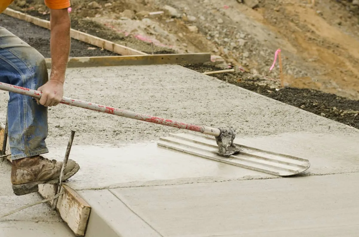 Crew finishing a fresh concrete pour on a J. Coble job site