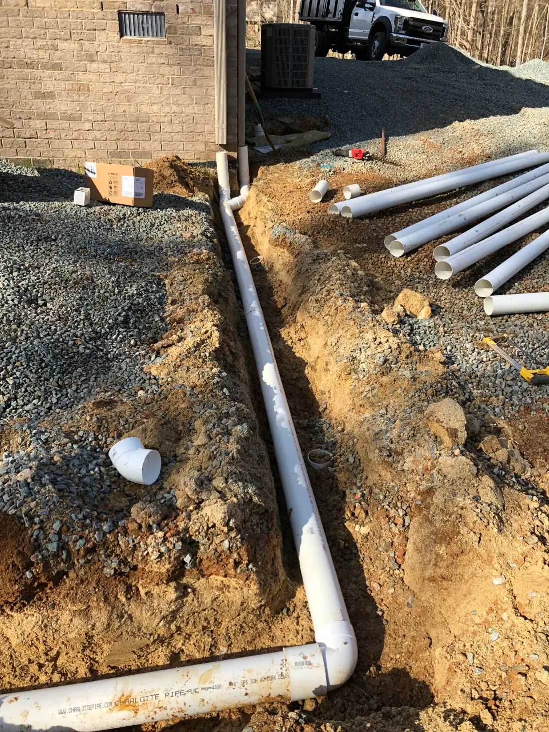 PVC French drain and downspout piping installed on a J. Coble drainage project